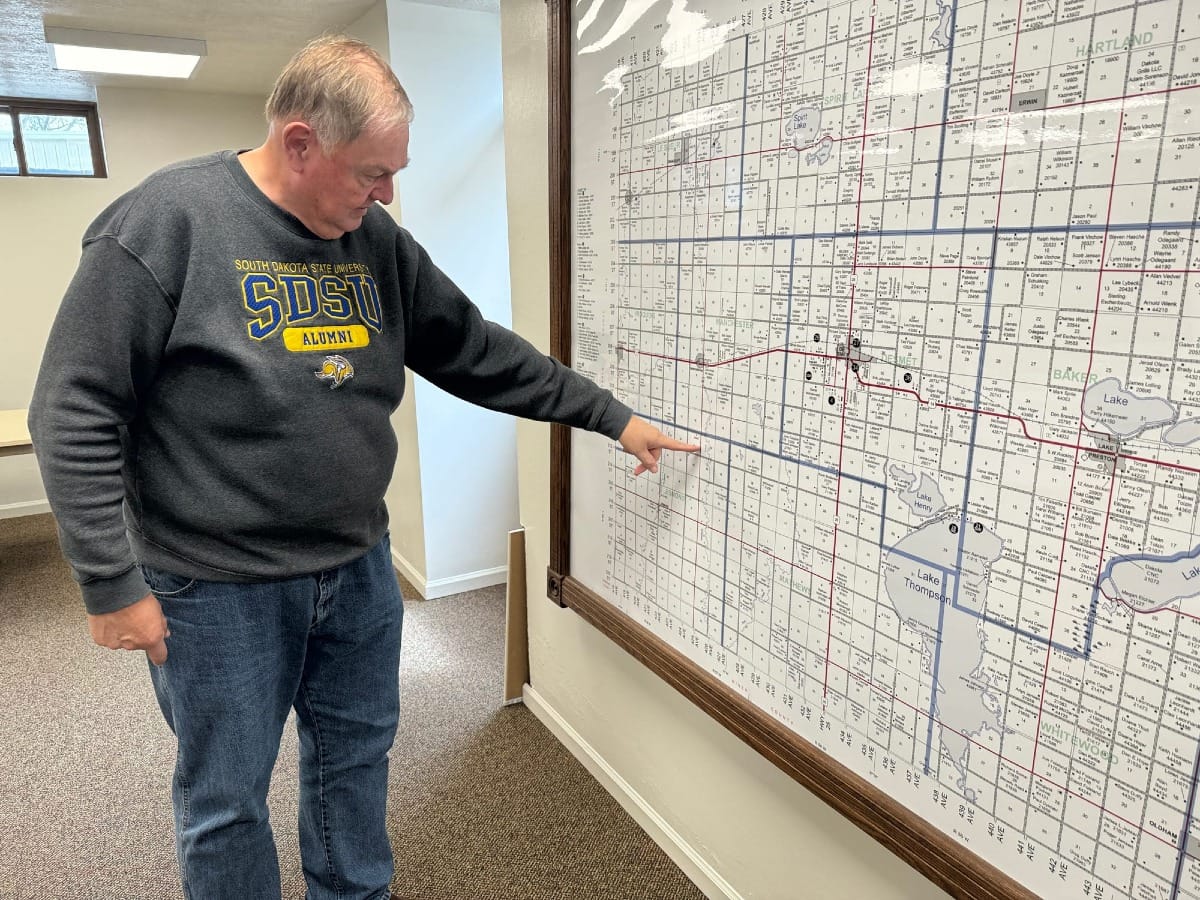 Kingsbury County zoning officer Joe Jensen points to the location on a map where a large dairy operation with up to 25,000 cows will be located in Kingsbury County, South Dakota.