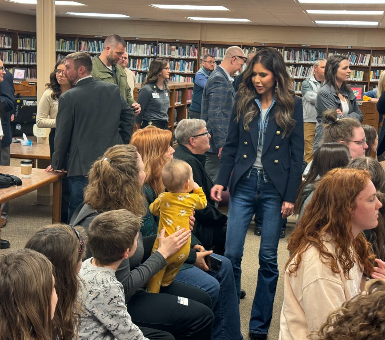 South Dakota Gov. Kristi Noem speaks with constituents at a library