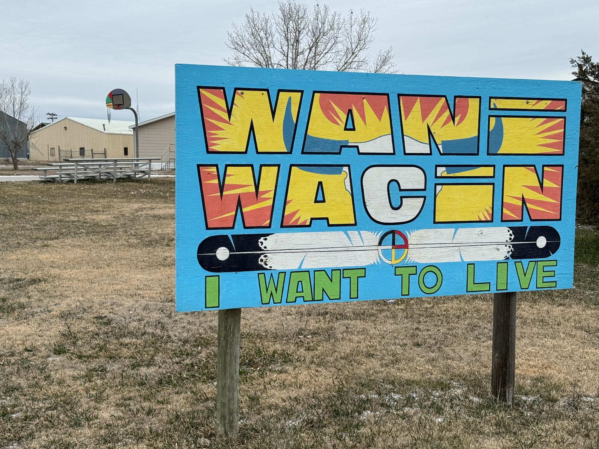 This sign stands outside a youth center on March 23, 2024, in Lower Brule, S.D., refers to the ultimate goal of health care across South Dakota. 