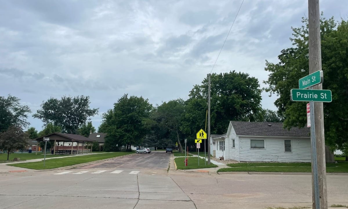 A residential street in Harrisburg, South Dakota, with a park and a home pictured