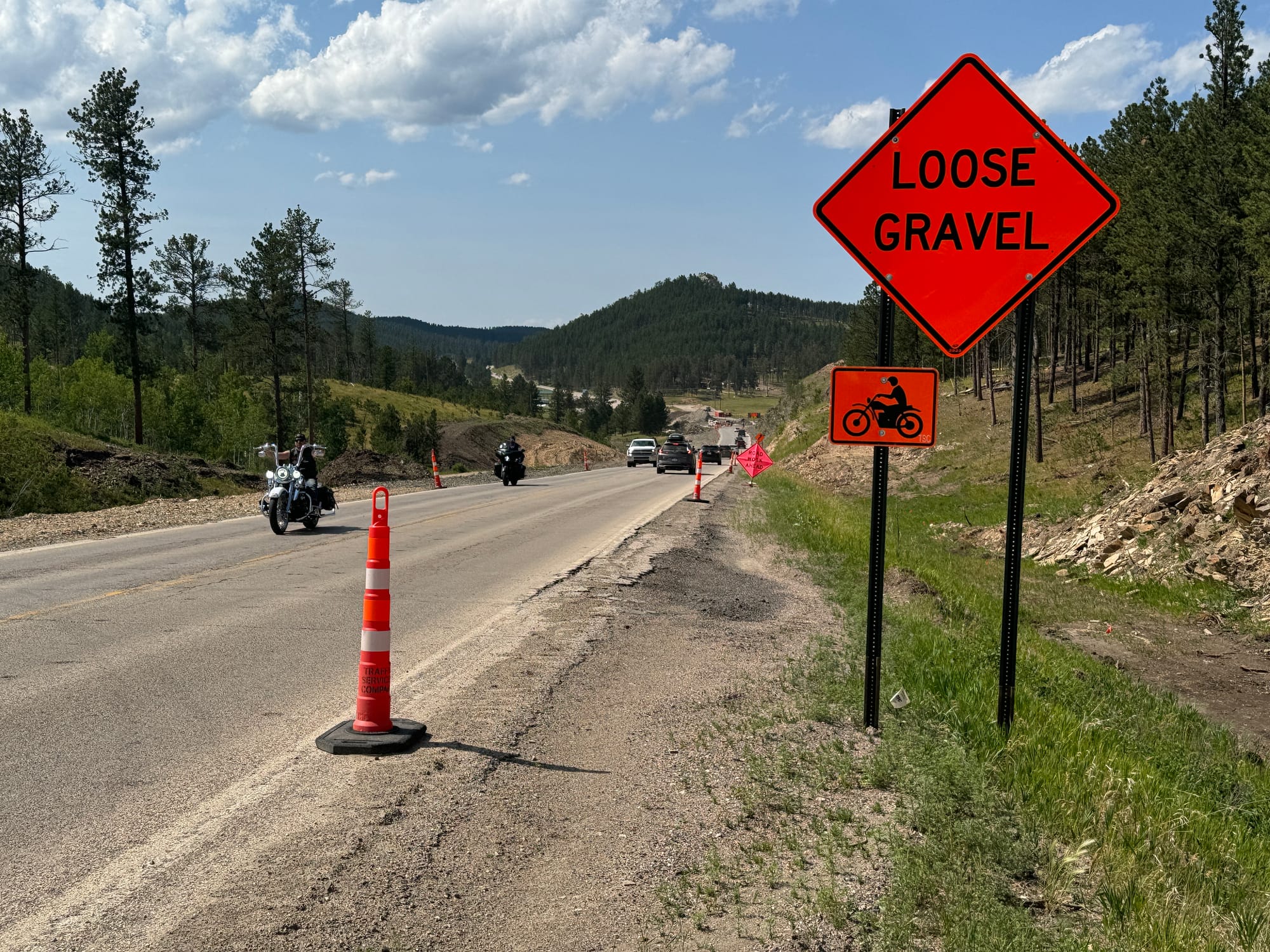 Cars and motorcycles travel down Highway 385 during construction in the Black Hills