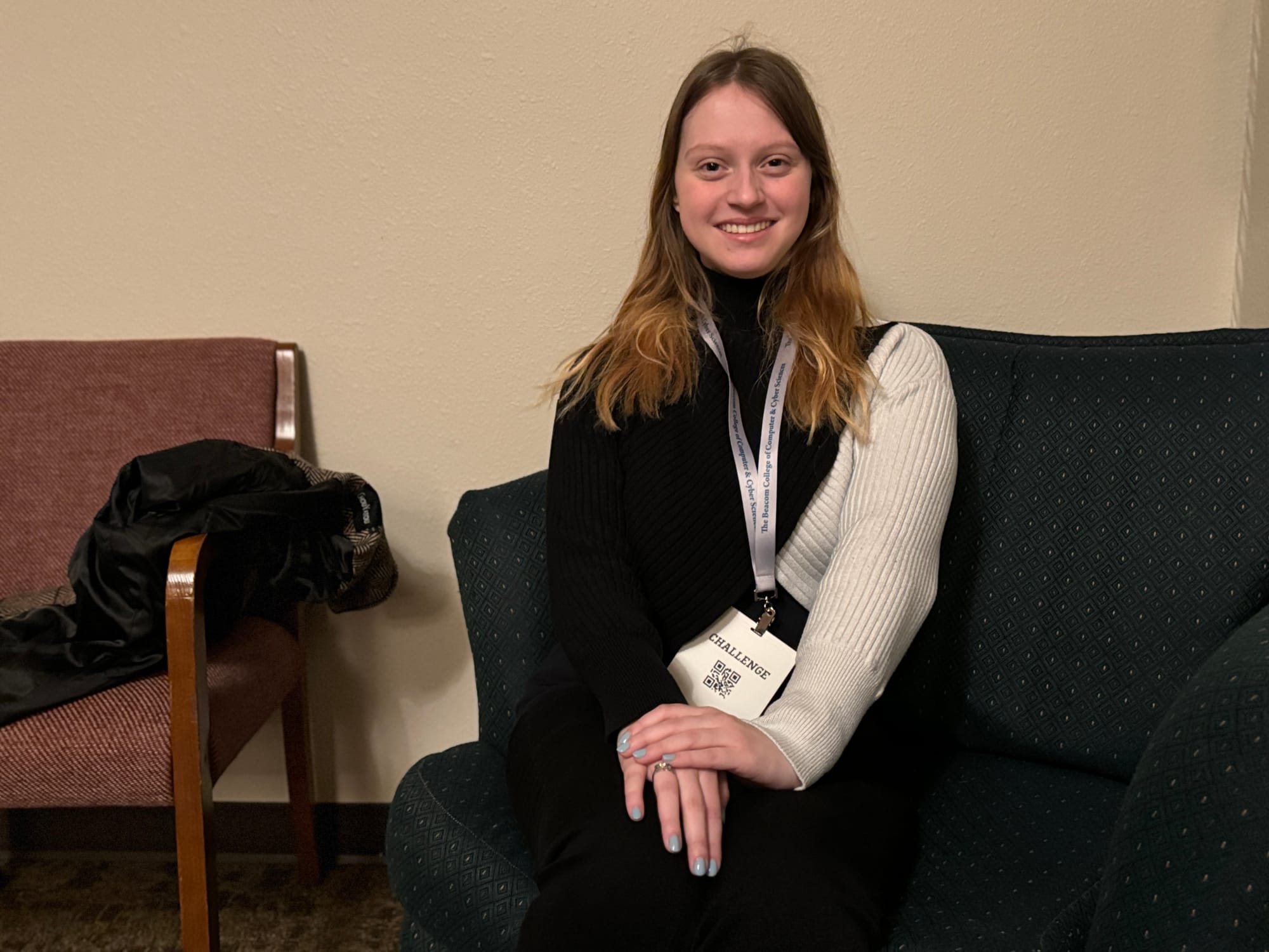 Alexis Kulm poses for a photo on a couch on the Dakota State University campus