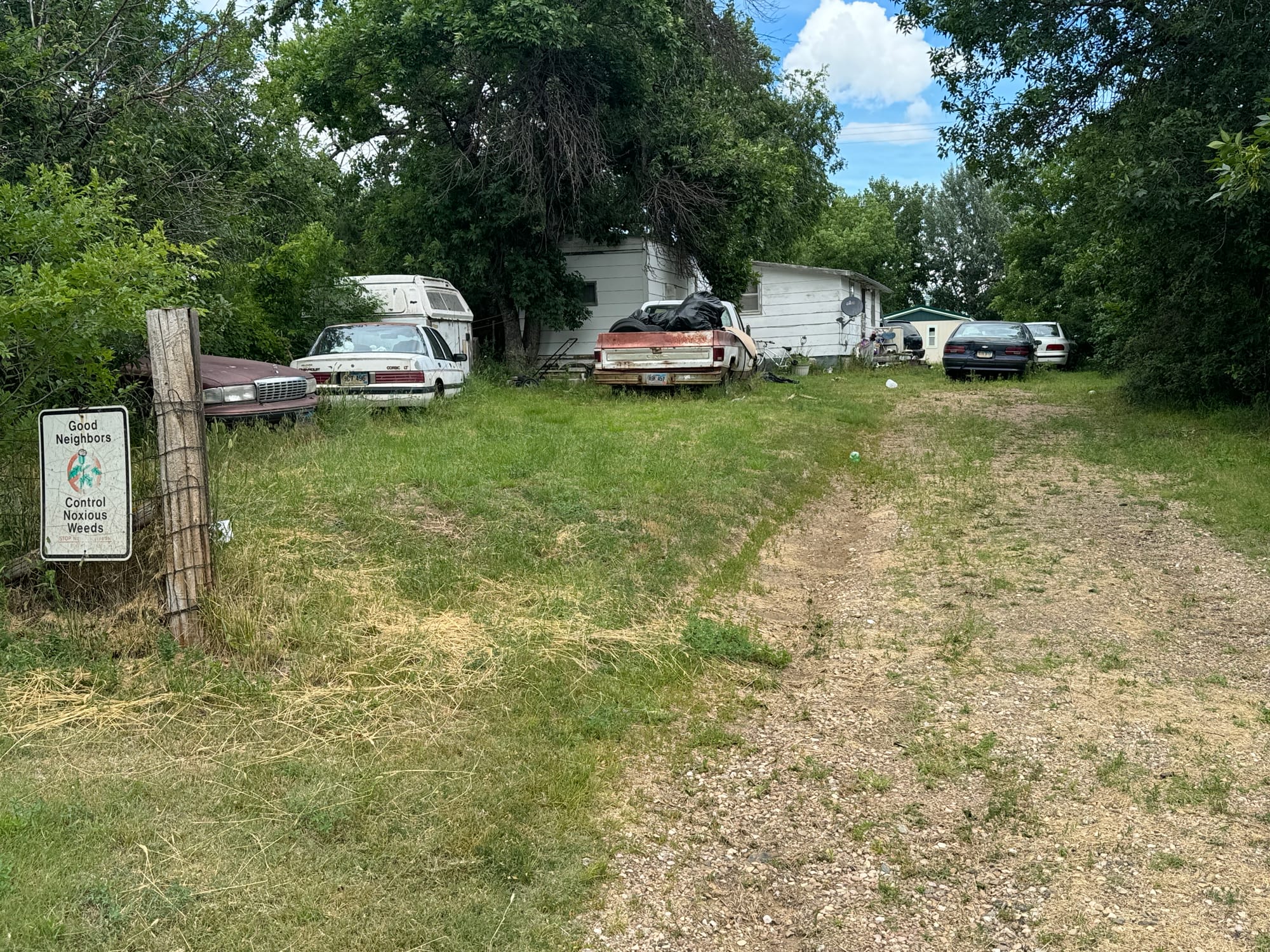 Old vehicles sit in a property in Faith, South Dakota.