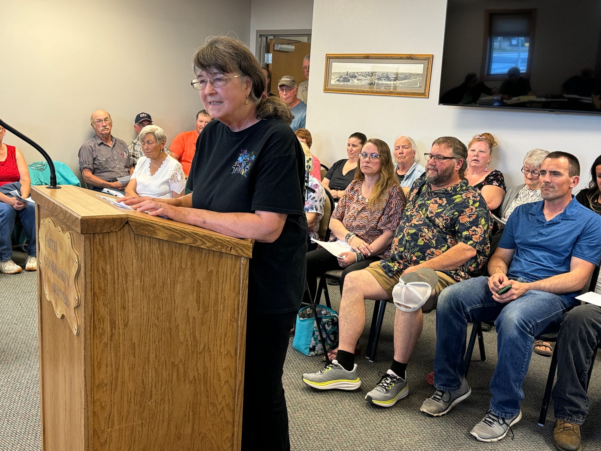 Business owner Diana Bottjen of Faith, S.D., testified against the city's new, stricter code enforcement policy at a crowded city council meeting