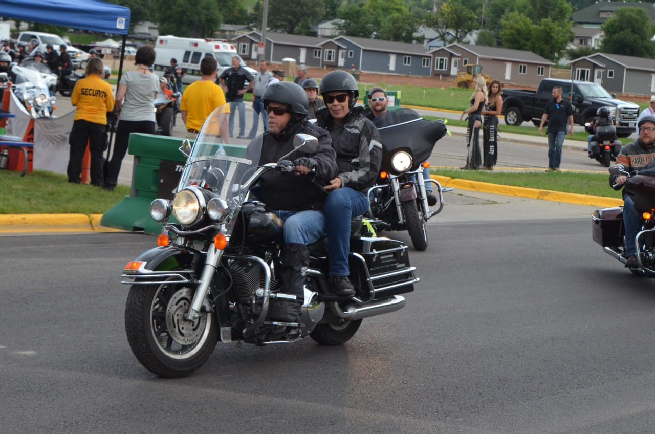 A couple ride a motorcycle in Sturgis, South Dakota