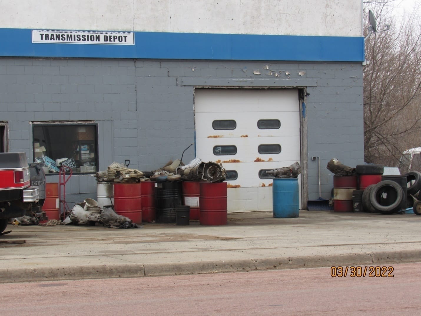 Dudley Schroeder's transmission shop in armour, South Dakota, is pictured with junk and tires in front of it.