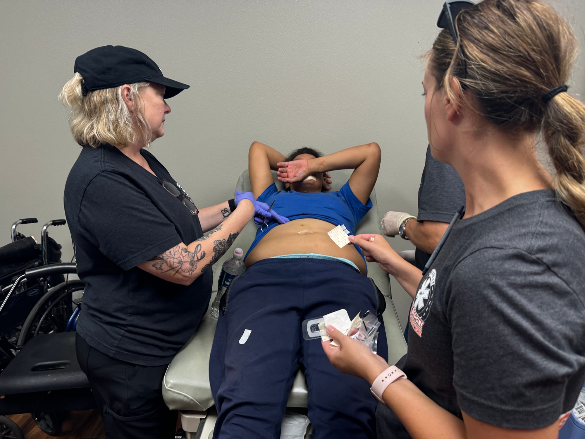 Midwest Street Medicine volunteers tend to a woman who was stabbed in the face and the abdomen.