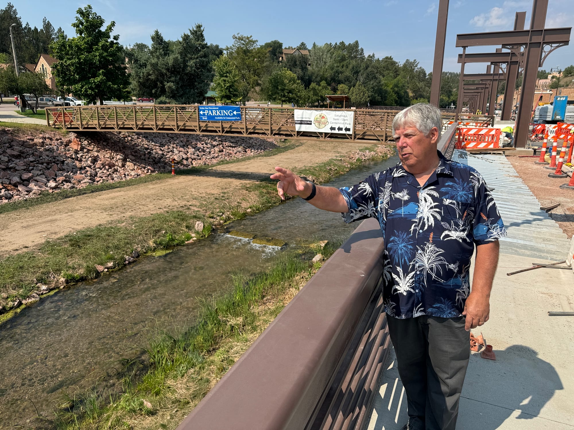 Hot Springs mayor Bob Nelson points at an elevated sidewalk in the city.