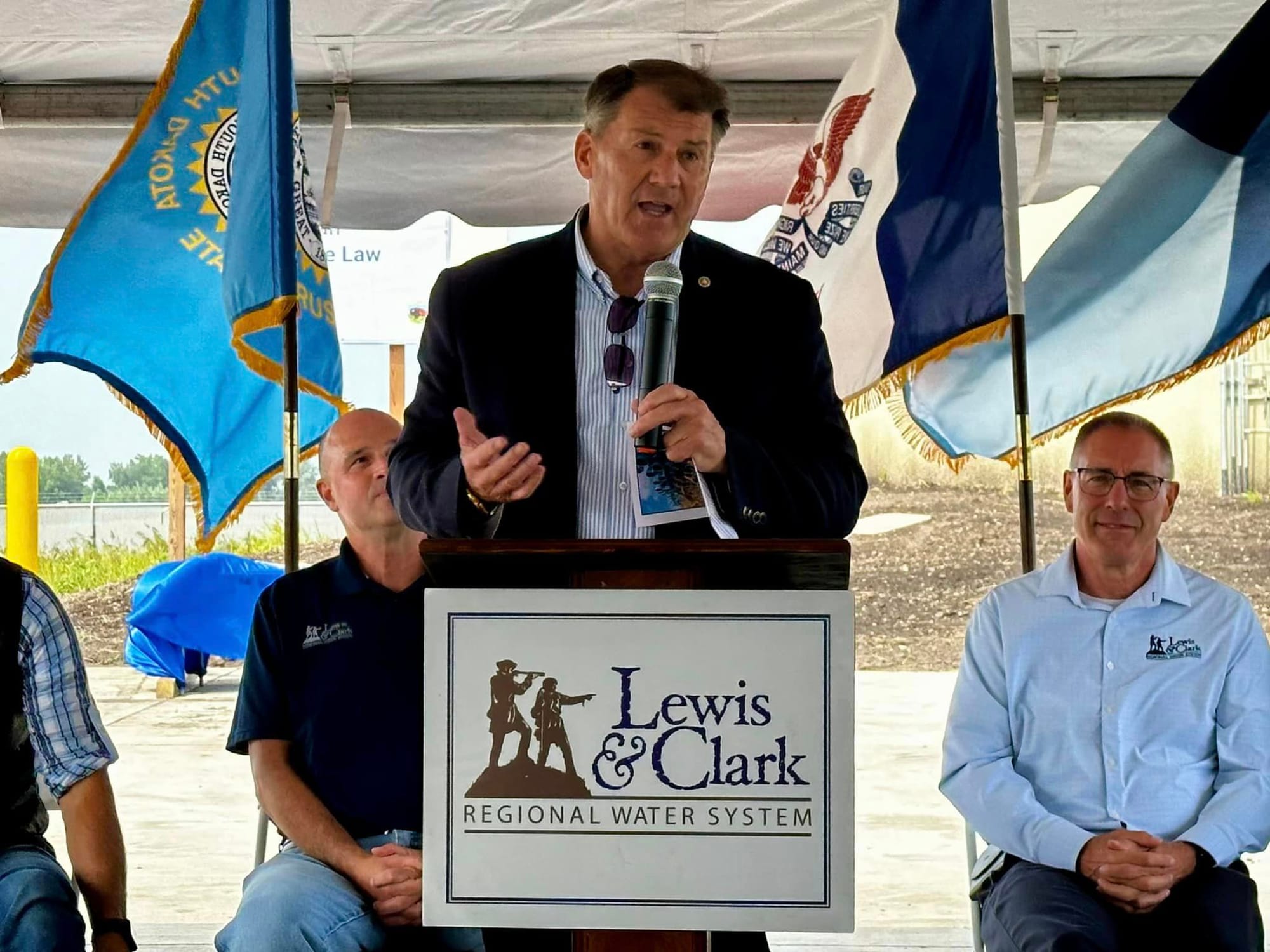 Sen. Mike Rounds speaks to a crowd from a podium..