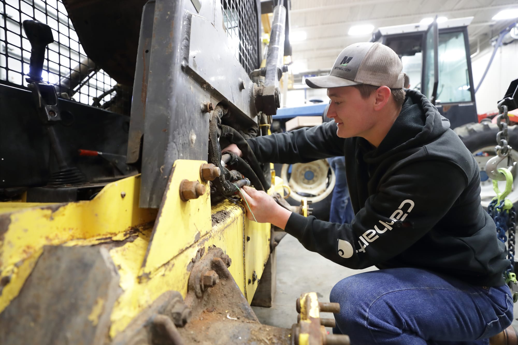 A college student works on a diesel tractor at Mitchell Technical College.