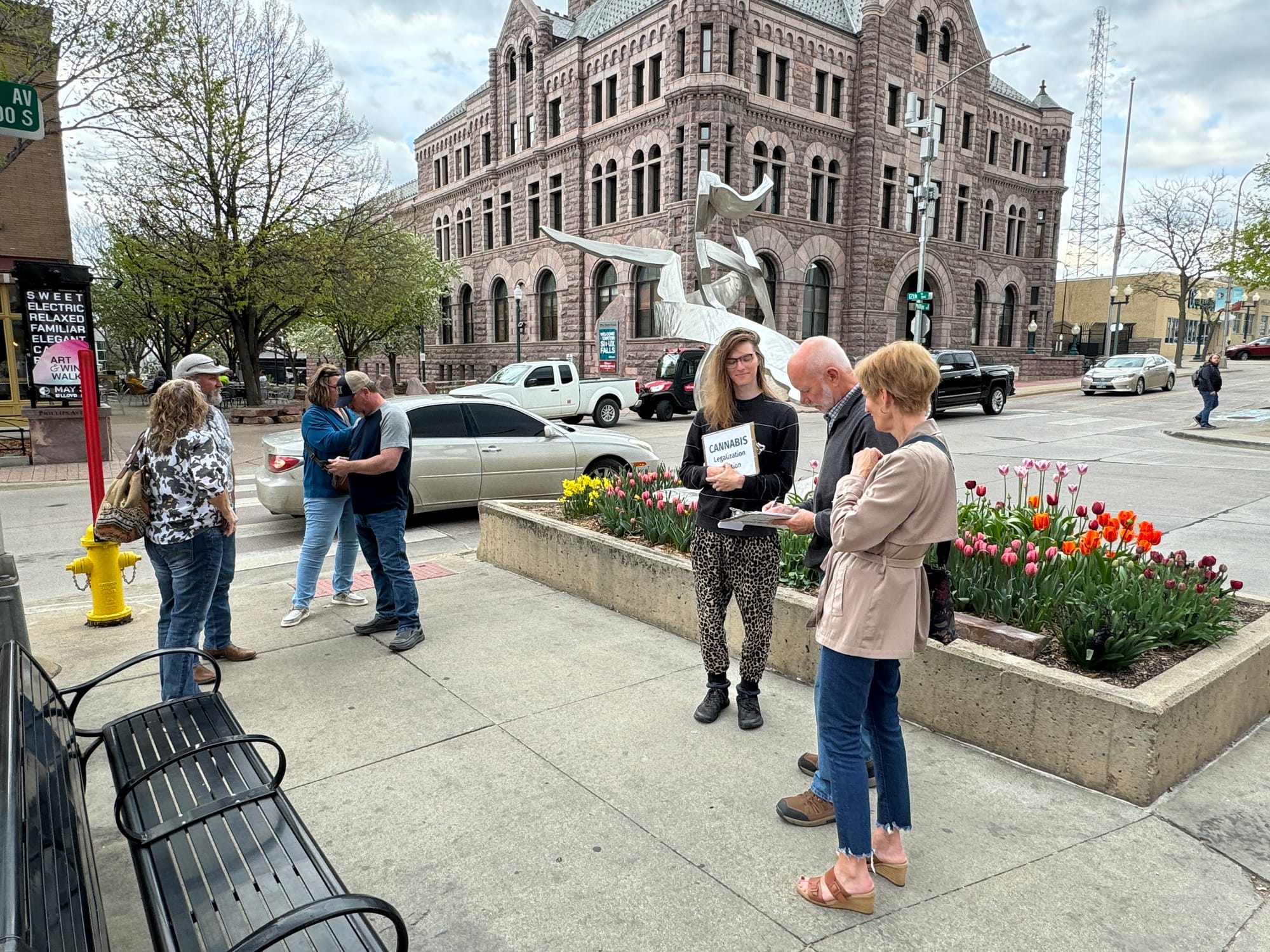 People gather petition signatures for a recreational marijuana ballot measure in downtown Sioux falls.