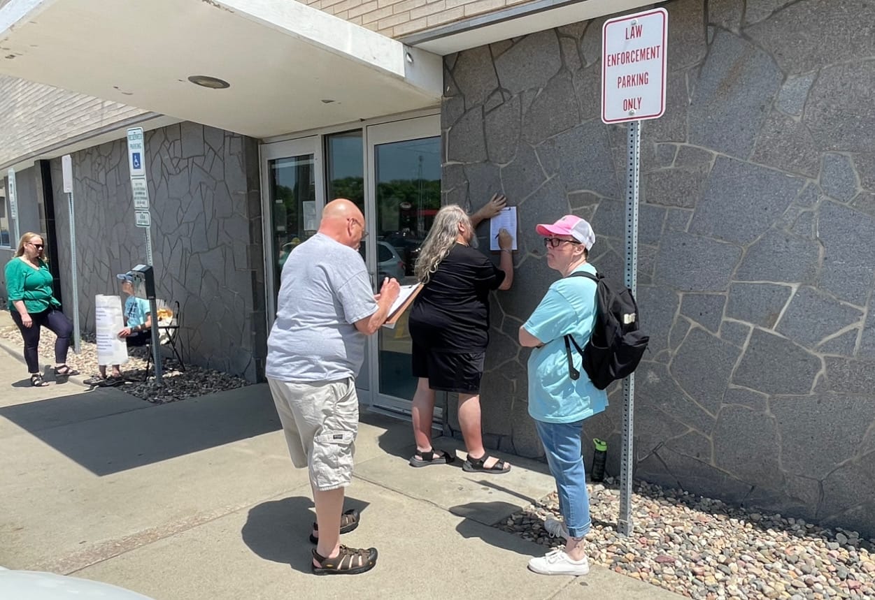 Registered voters sign a petition outside the Minnehaha County courthouse.