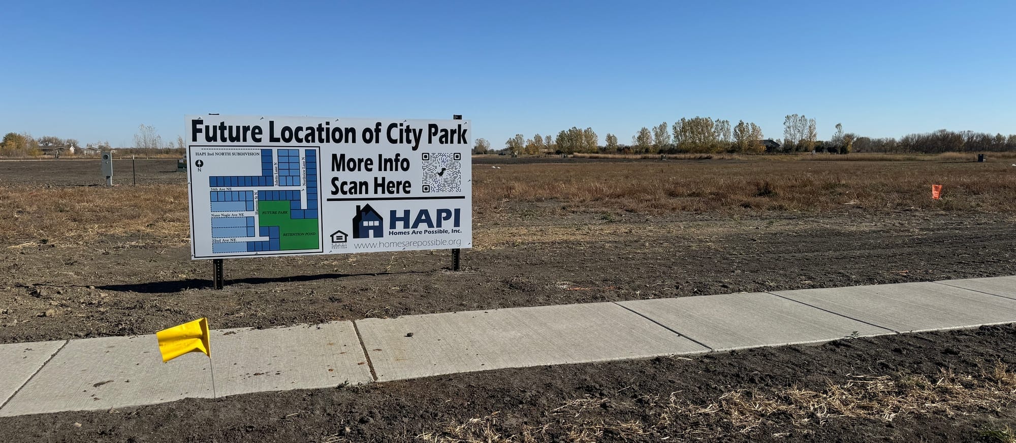 A sign in an empty field indicating future homes being built in Aberdeen, South Dakota.