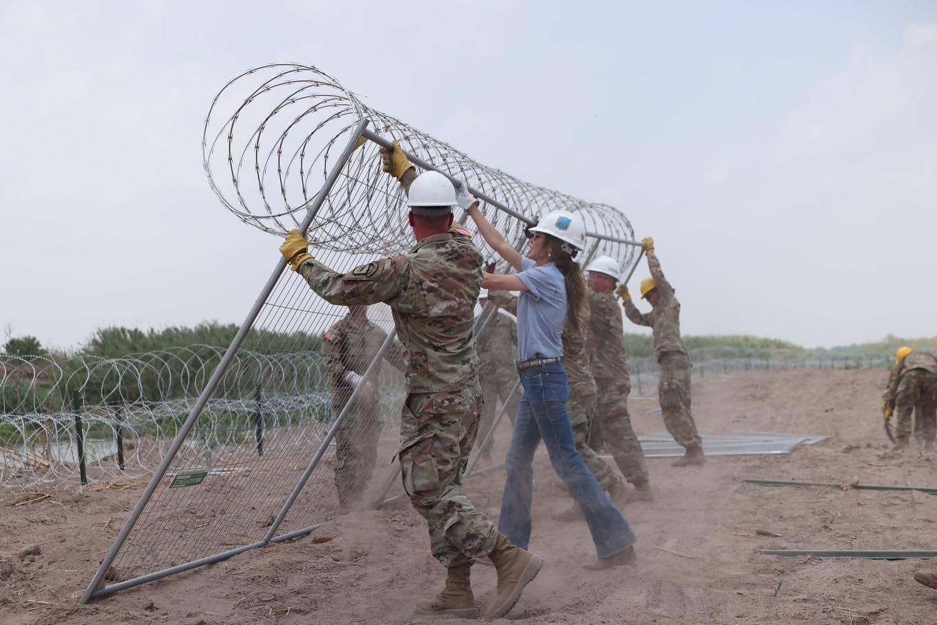 Gov. Kristi Noem helps South Dakota Guard soldiers construct a wall on the southern border.