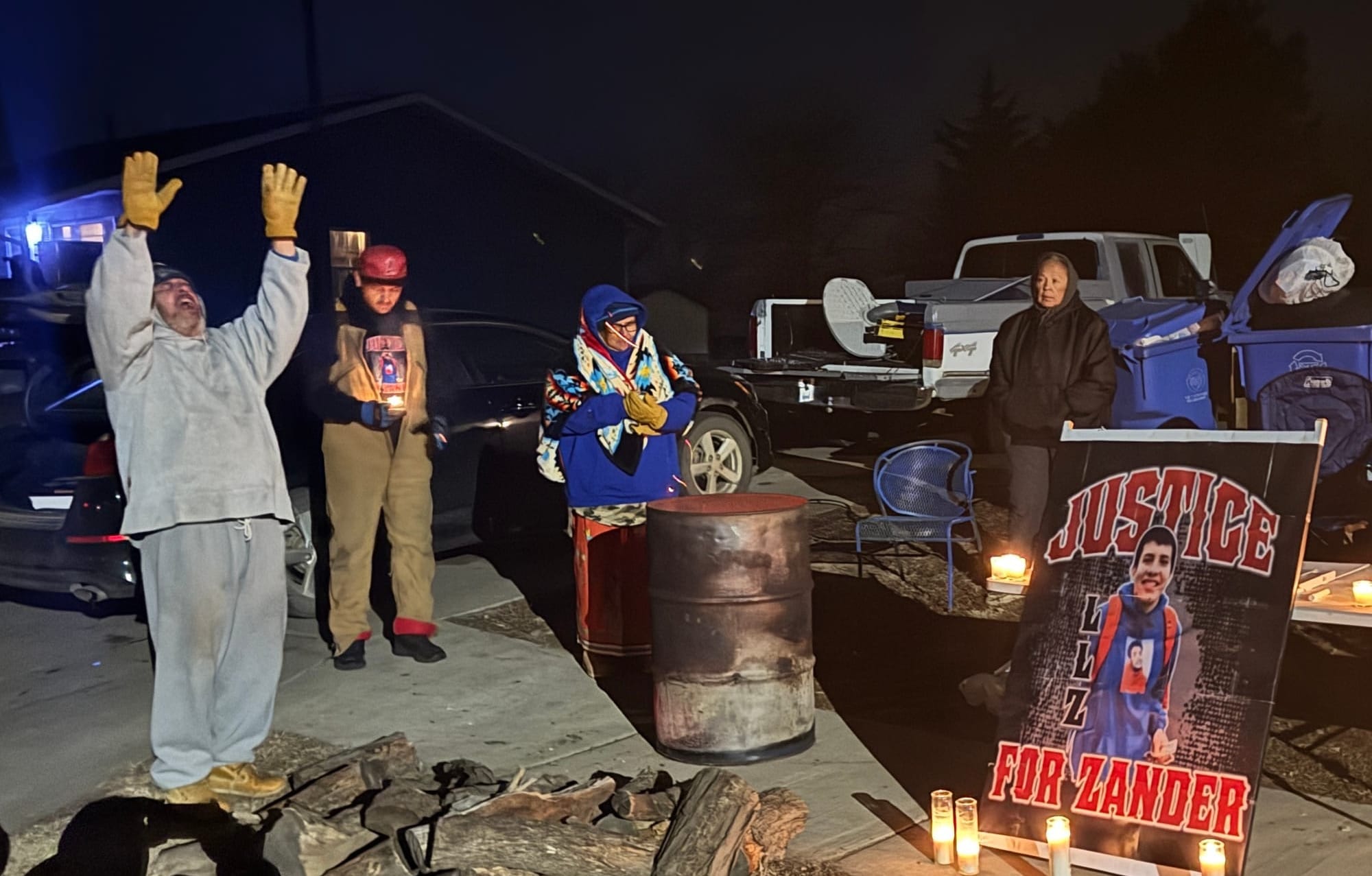 Robin Bair (left) of the Yankton Sioux Tribe sings a calling song at a candlelight vigil held Dec. 11, 2024, for Zander Zephier 