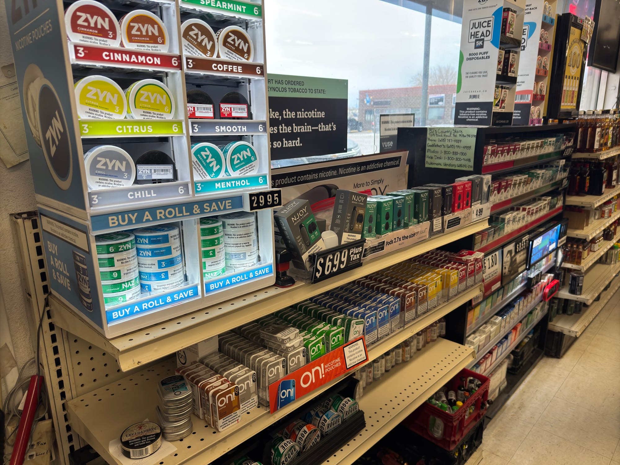 Tobacco products on a shelf in a grocery store