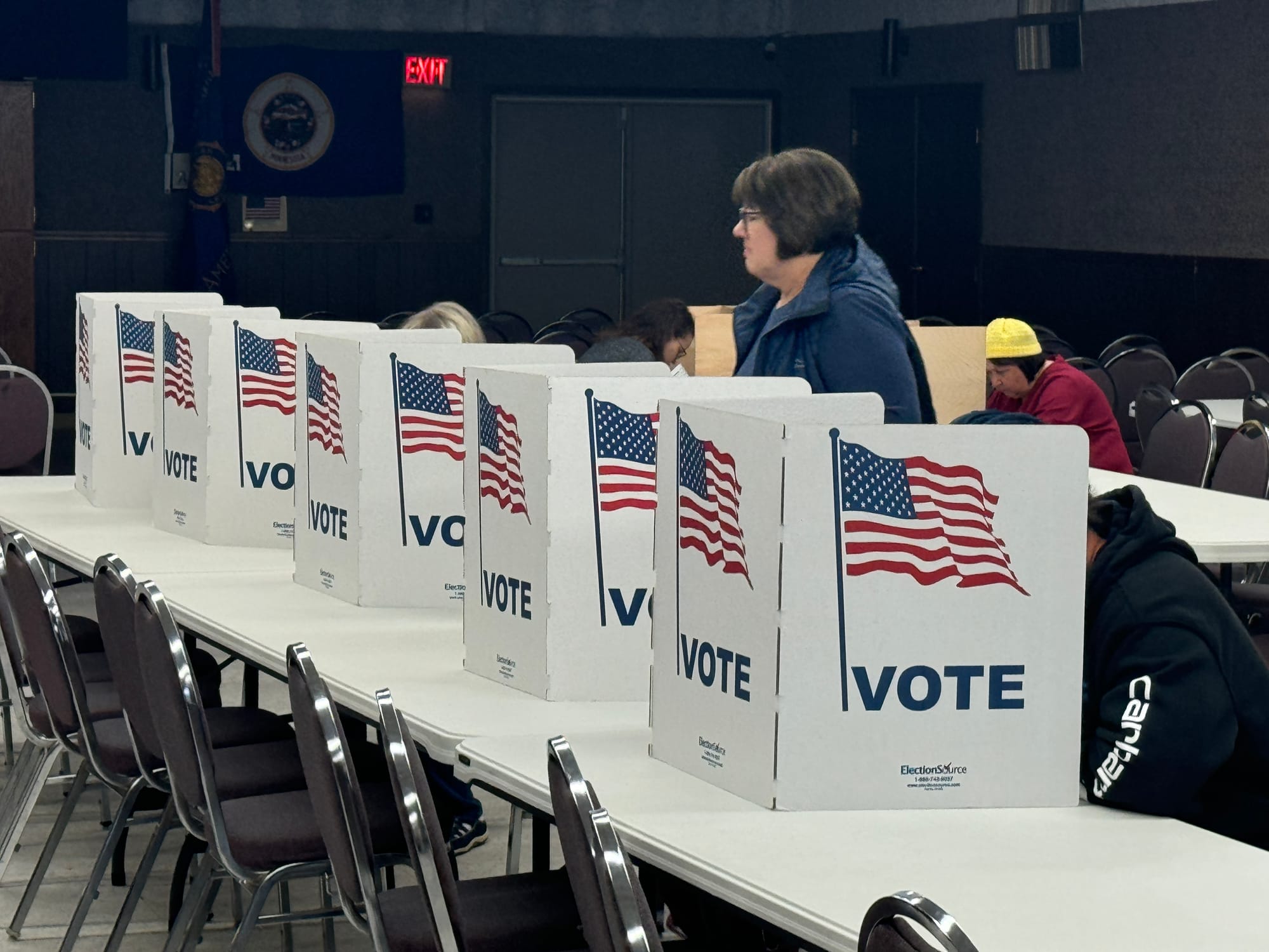 A woman prepares to fill out her ballot at a voting precinct inside the American Legion building in Valley Springs, S.D.,