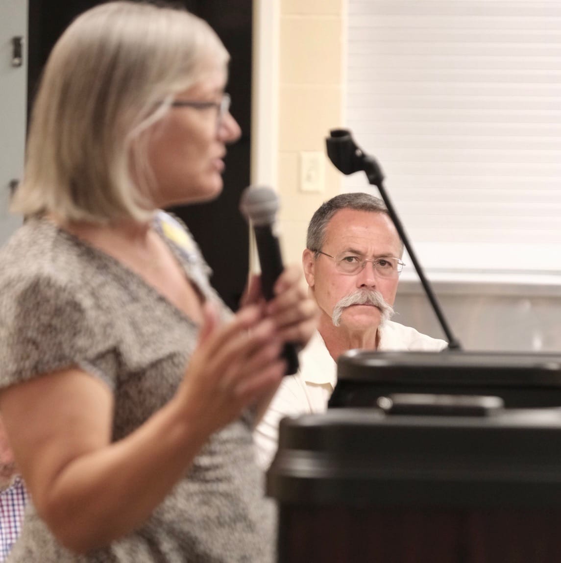 Jim Eschenbaum of the South Dakota Property Rights and Local Control Alliance listens to Democratic U.S. House candidate Sheryl Johnson