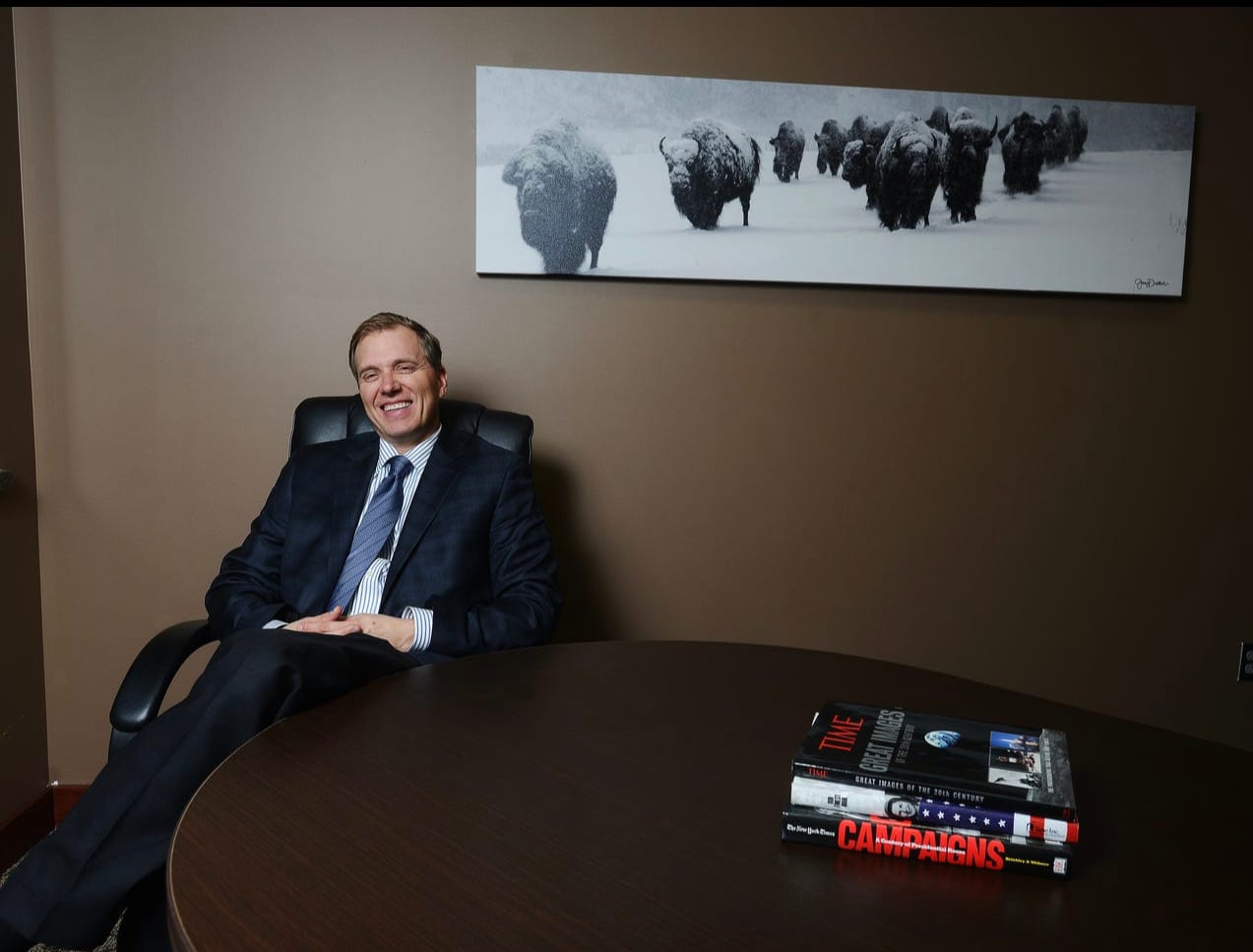 Mark Mickelson sits at a table and poses for a photo