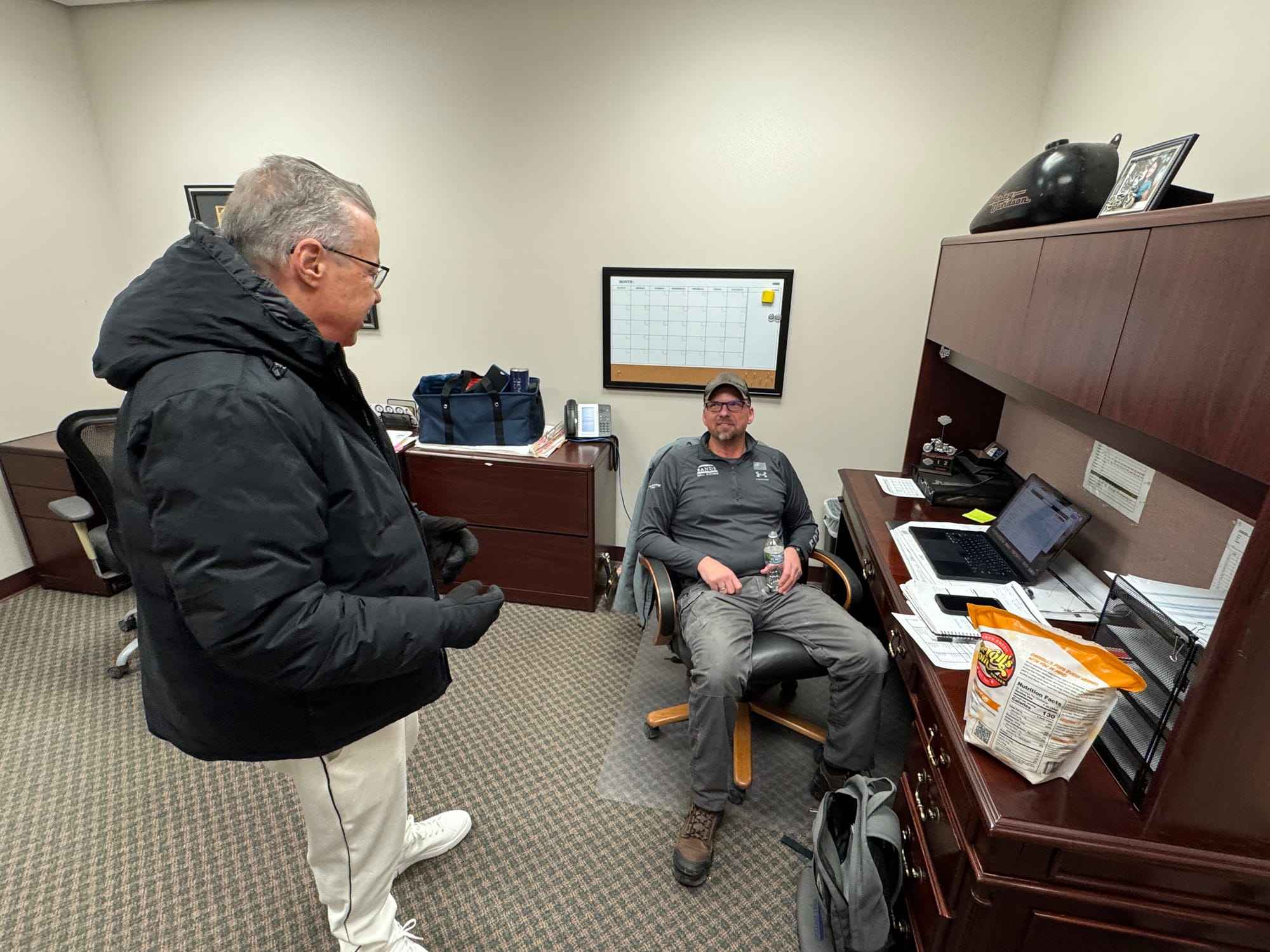 Greg Sands (left) talks with longtime Sands Wall Systems employee Terry Curl,