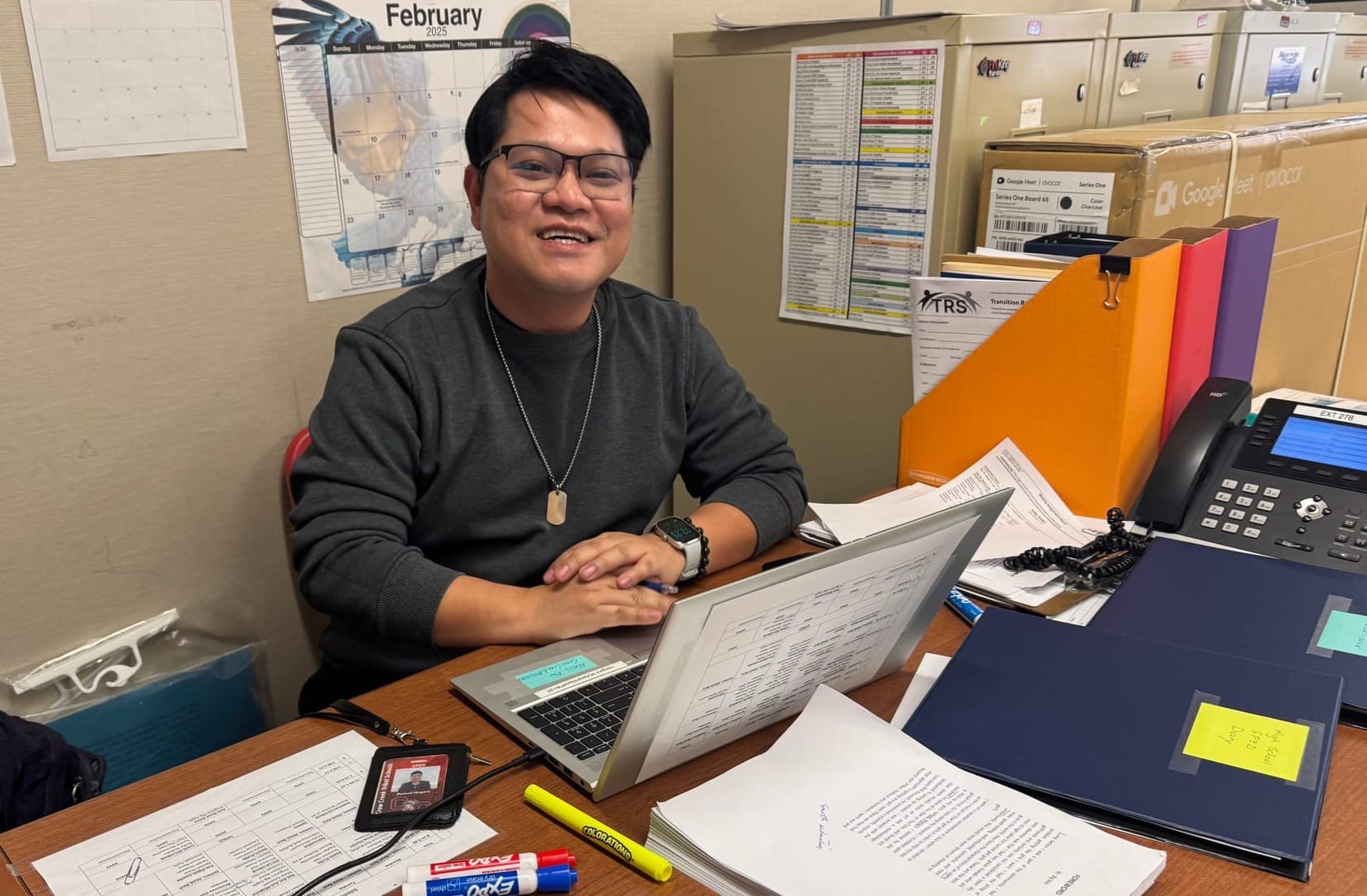 Ronneil Vergara sits at his desk in front of his computer