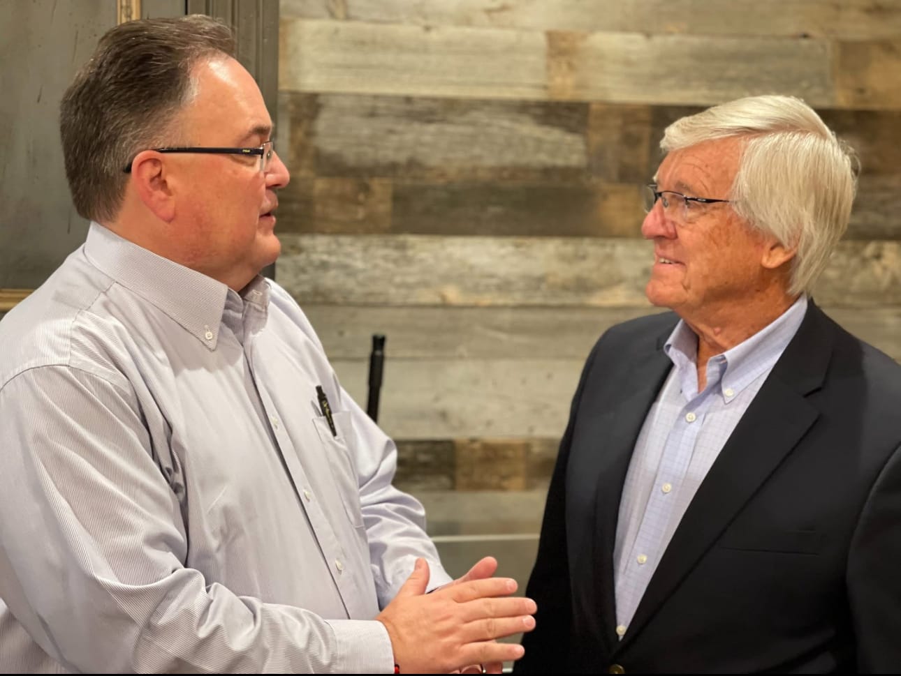 Two men, including Jim Schmidt (right), have a conversation together.