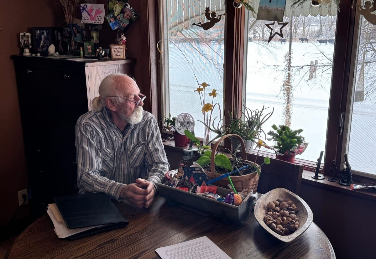 Tom Eiesland sits at the kitchen table of his home in rural Canton, S.D., 