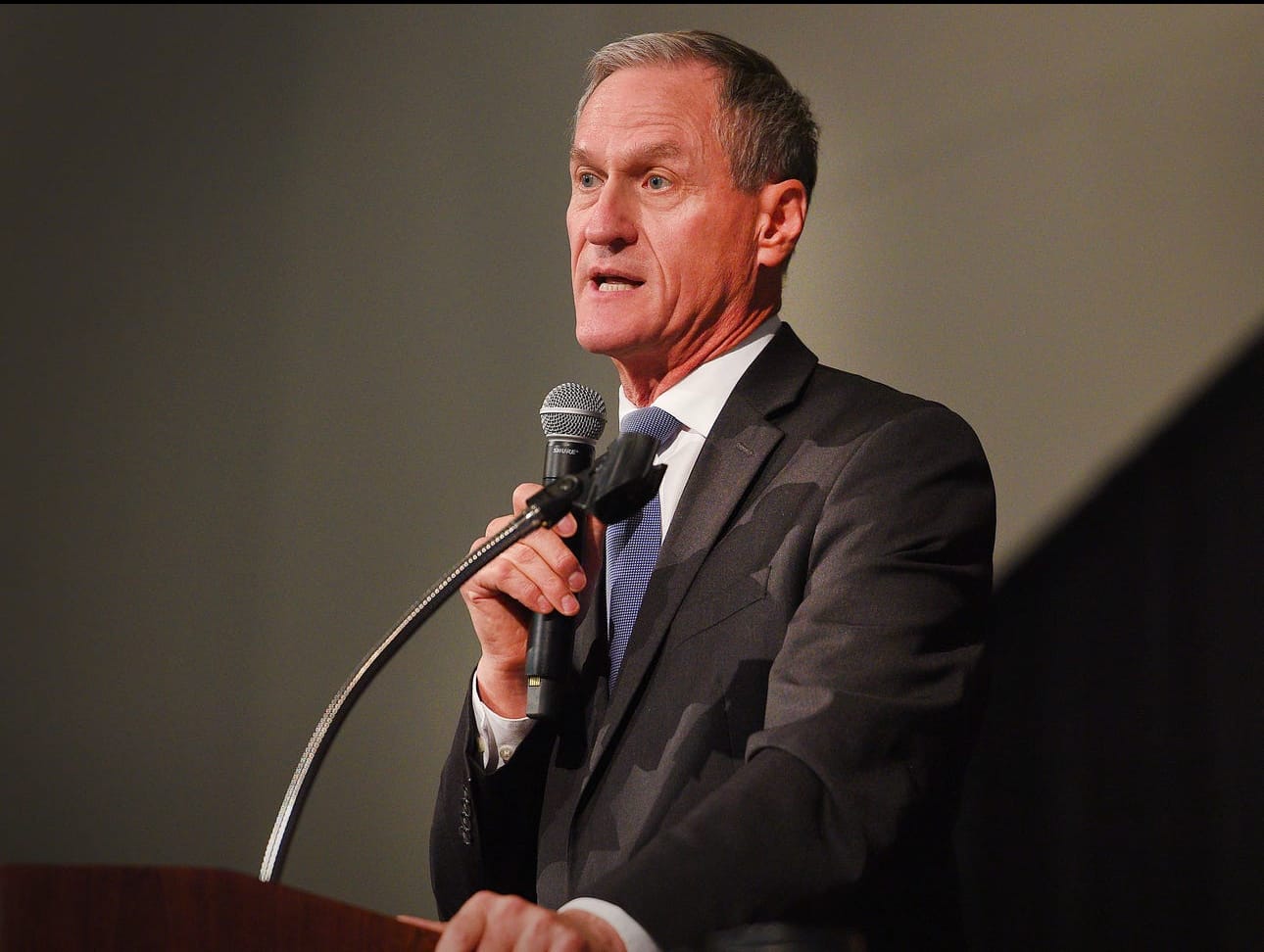 Former South Dakota Gov. Dennis Daugaard speaks in front of a group of people