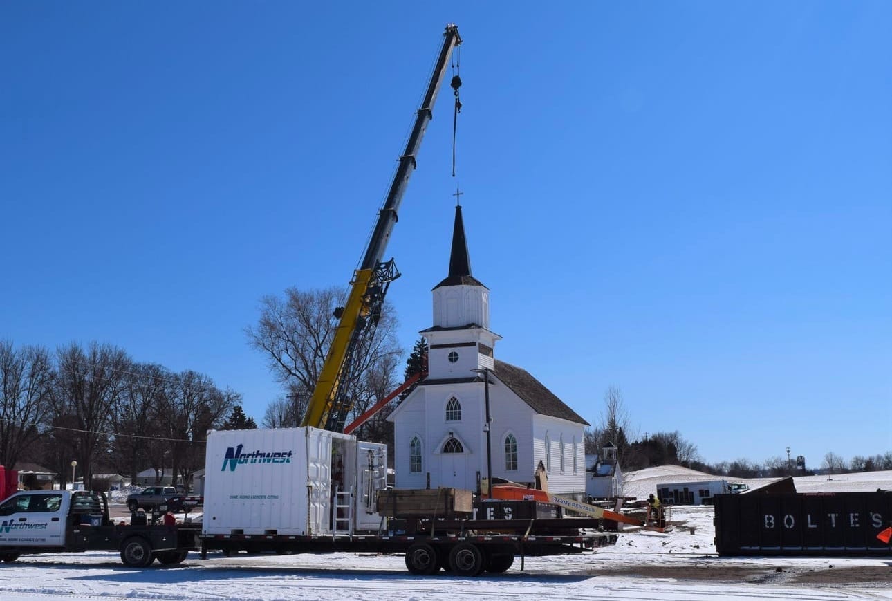 Construction crews prepare Beaver Creek Lutheran Church to be moved from the campus of Augustana University