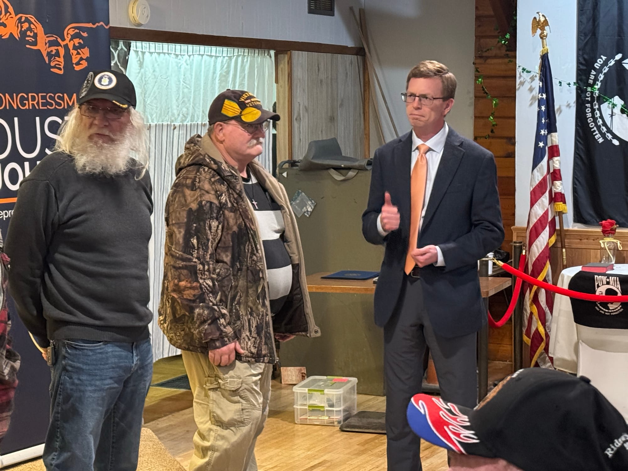 U.S. Rep. Dusty Johnson, right, stands with veterans Robert Orr, left, and Kent Popham, 