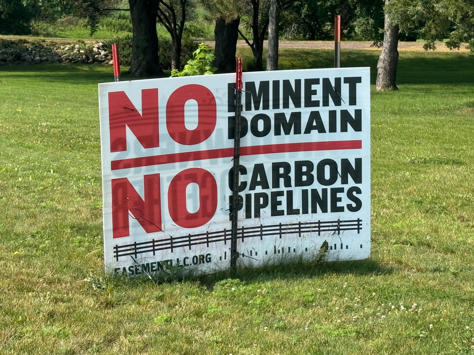 A sign protesting the potential use of eminent domain to access land for carbon pipelines appears July 20, 2024, in Lincoln County