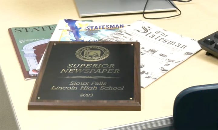 A high school newspaper award for Sioux Falls Lincoln sits on a table. 