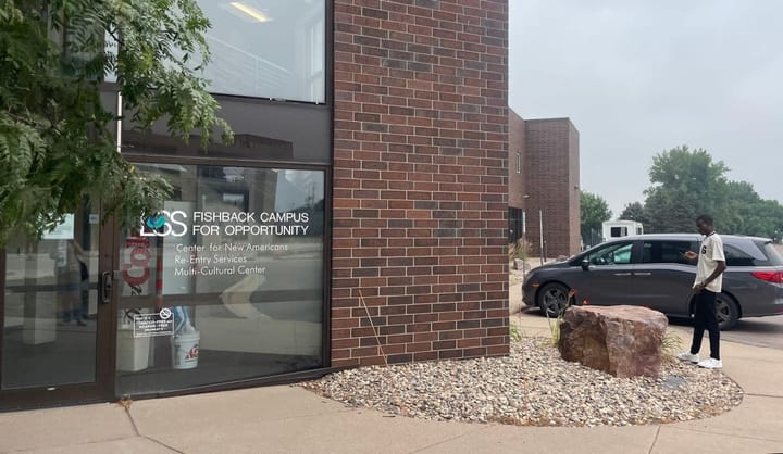 The exterior of Lutheran Social Services Center in Sioux Falls, a brick building with glass windows. 