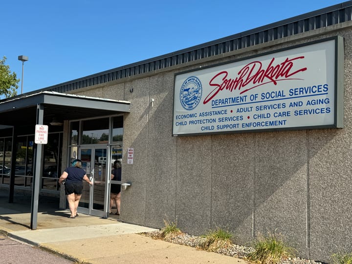 A woman walks into the South Dakota Department of Social Services building in Sioux Falls..