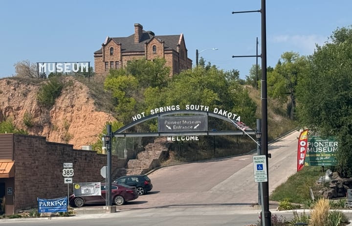 A historic building sits on a hit in Hot Springs, South Dakota.